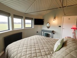 A bedroom with a bed and television at Unit 1 Ipswich