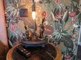 A lamp featuring rabbit figurines in a living room at Unit 1 in Ipswich