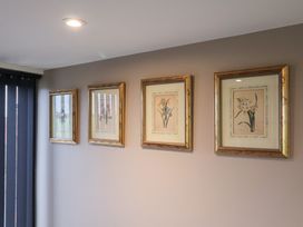 Four framed artworks on a wall at Unit 1 Ipswich