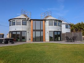 An outdoor view of a modern building with round structures at The Corn Silo in Ipswich