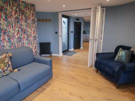 A living room with a sofa and armchair at Unit 2 in Ipswich