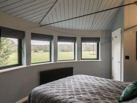 A bedroom with a bed and multiple windows at Unit 2 Ipswich