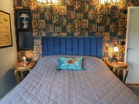 A bedroom with a bed and decorative wall at Unit 2 Ipswich