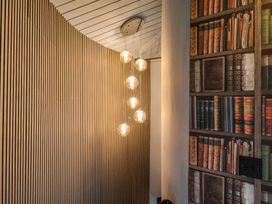 A hallway featuring wood paneling and a pendant light fixture at Unit 2 Ipswich
