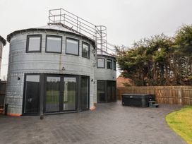 A house with metal exterior and hot tub at Unit 2 in Ipswich