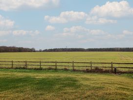 A field with a fence and power pole at Unit 2 Ipswich