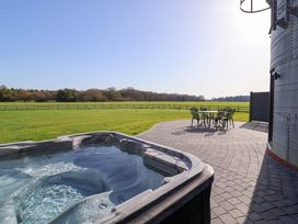 An outdoor area with a hot tub and seating at The Barley Silo in Ipswich