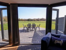 A lounge area with a view of a patio and chairs at The Barley Silo in Ipswich