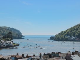 A view of water with boats and hills at Ty'r Ddraig in Dartmouth