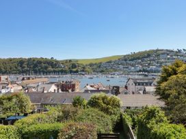 A view of waterfront with boats and buildings at Ty'r Ddraig in Dartmouth