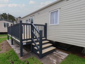 A mobile home with a deck and steps at No. 7 Ivy Scarborough