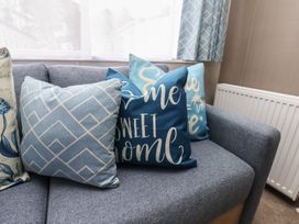 A sofa with decorative cushions at No. 7 Ivy Scarborough