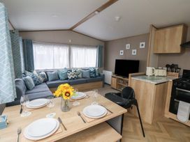 A living room with a sofa and television at No. 7 Ivy in Scarborough