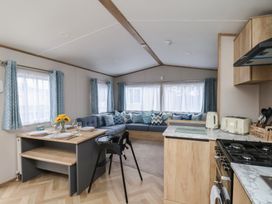 A living room with a sofa and dining table at No. 7 Ivy in Scarborough