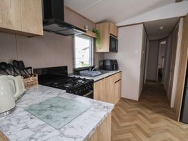 A kitchen with a stove, sink and cabinetry at No. 7 Ivy in Scarborough