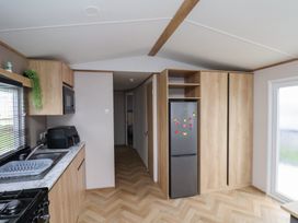 A kitchen with sink and refrigerator at No. 7 Ivy Scarborough