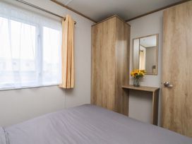 A bedroom with a bed and a window at No. 7 Ivy in Scarborough