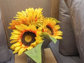 A bouquet of sunflowers in a vase on a table at No. 7 Ivy Scarborough