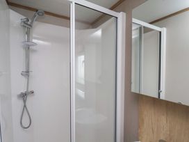 A bathroom with a shower and mirror at No. 7 Ivy Scarborough