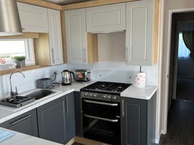 A kitchen with appliances and sink at TW89 in Exmouth