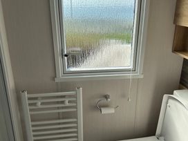 A bathroom with a toilet and towel rail at TW89 Exmouth