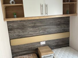 A bedroom with a bed and nightstand at TW89 in Exmouth