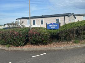 A mobile home with a sign for Tamarisk Way in Exmouth