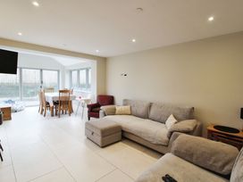 A living room with a sofa and dining area at Cefn Coed in Presteigne