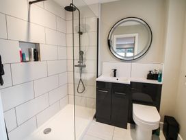 A bathroom with a shower, sink and toilet at Cefn Coed in Presteigne