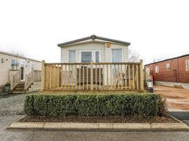 A mobile home with decking and bush at Plot 42 in Carlisle