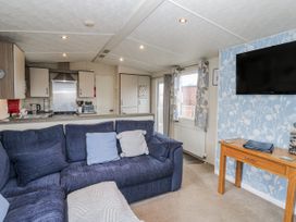 A living room with a sofa and television at Plot 42 in Carlisle