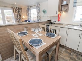 A kitchen with a dining table and chairs at Plot 42 Carlisle