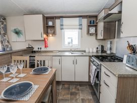 A kitchen with a dining table and chairs at Plot 42 in Carlisle