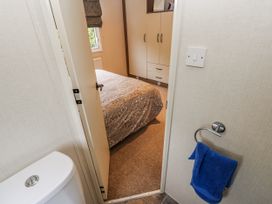 A bedroom with a bed and towel rack at Plot 42 in Carlisle