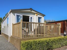 A mobile home with decking and a fence at Plot 42 Armathwaite