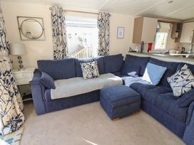 A living room with a sofa and a coffee table at Plot 42 in Armathwaite