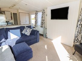 A living room with a sofa and television at Plot 42 in Armathwaite