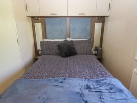 A bedroom with a bed and bedside table at Plot 42 in Armathwaite