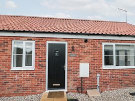 An exterior view of a house with a black door and windows at The Nest