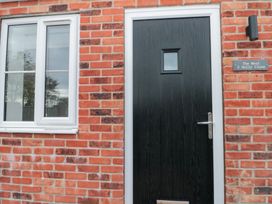 A black door and window on a brick wall at The Nest