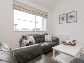 A living room with a sofa and table at The Nest