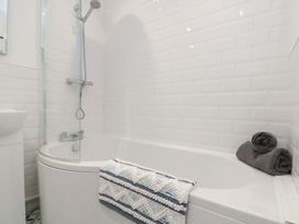 A bathroom with a bathtub and shower at The Nest in 
