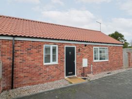A house with a black door and windows at The Nest in 