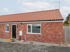 An exterior view of a brick building with a door and windows at The Nest in 