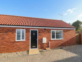 An exterior view of a brick house with windows and a door at The Nest Buckton near Bridlington