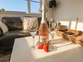 A living room with a champagne bottle and two flutes at The Nest Buckton near Bridlington
