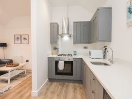 A kitchen with grey cabinets and countertop at The Nest in Buckton near Bridlington