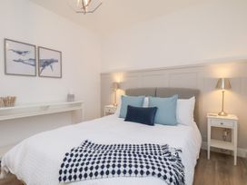 A bedroom with a bed and desk at The Nest in Buckton near Bridlington