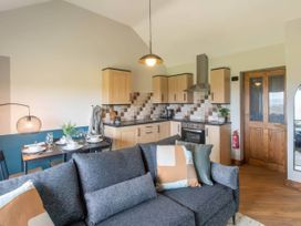 A kitchen with dining area at Black Bird Cottage Llangaffo