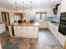 A kitchen with an island and appliances at Ty-Gan Dderwen in Llanelli